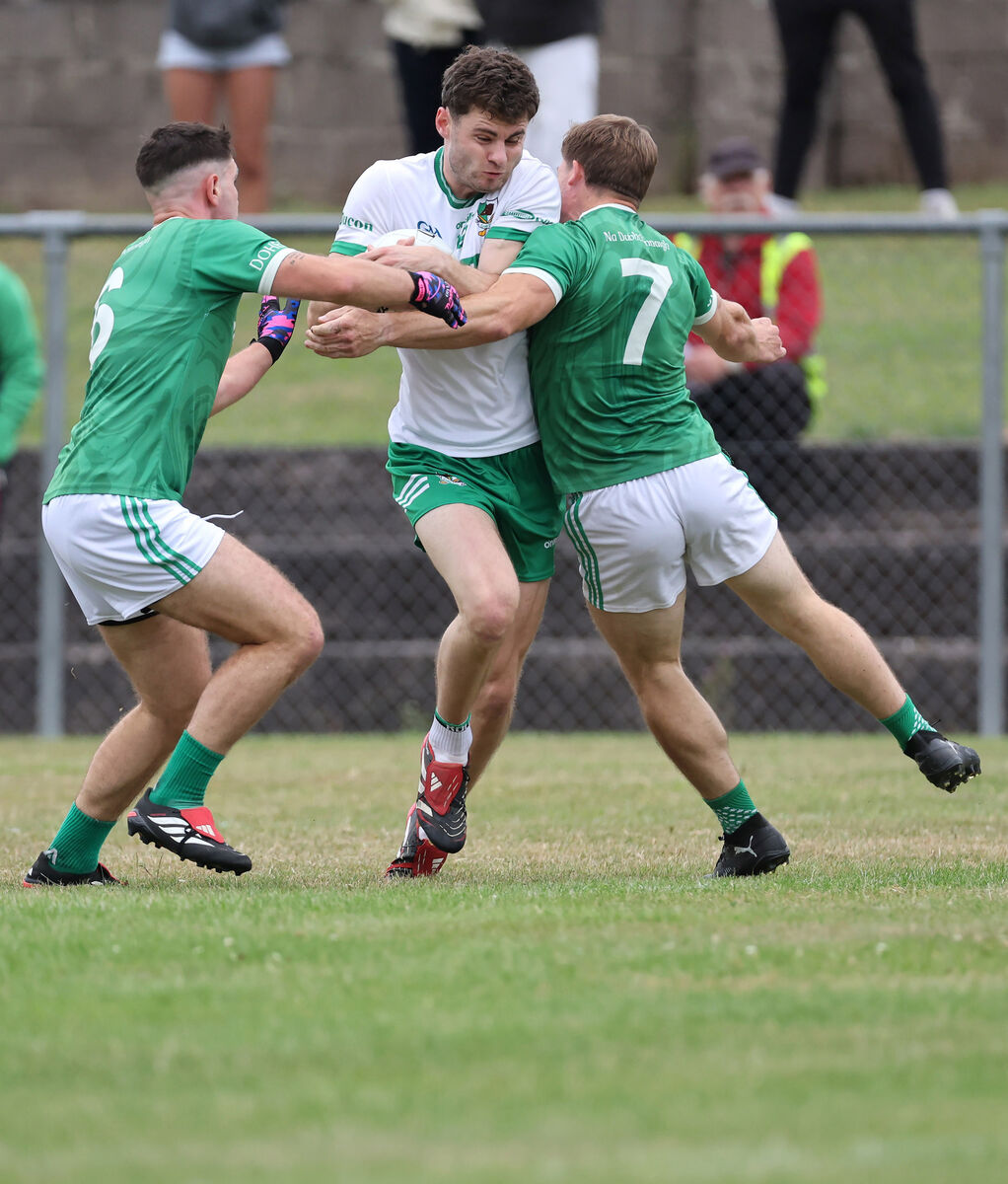  Daniel O'Connell, Kanturk, tries to get past Jerry Collins and Donal Rice, Dohenys. Picture: Jim Coughlan.