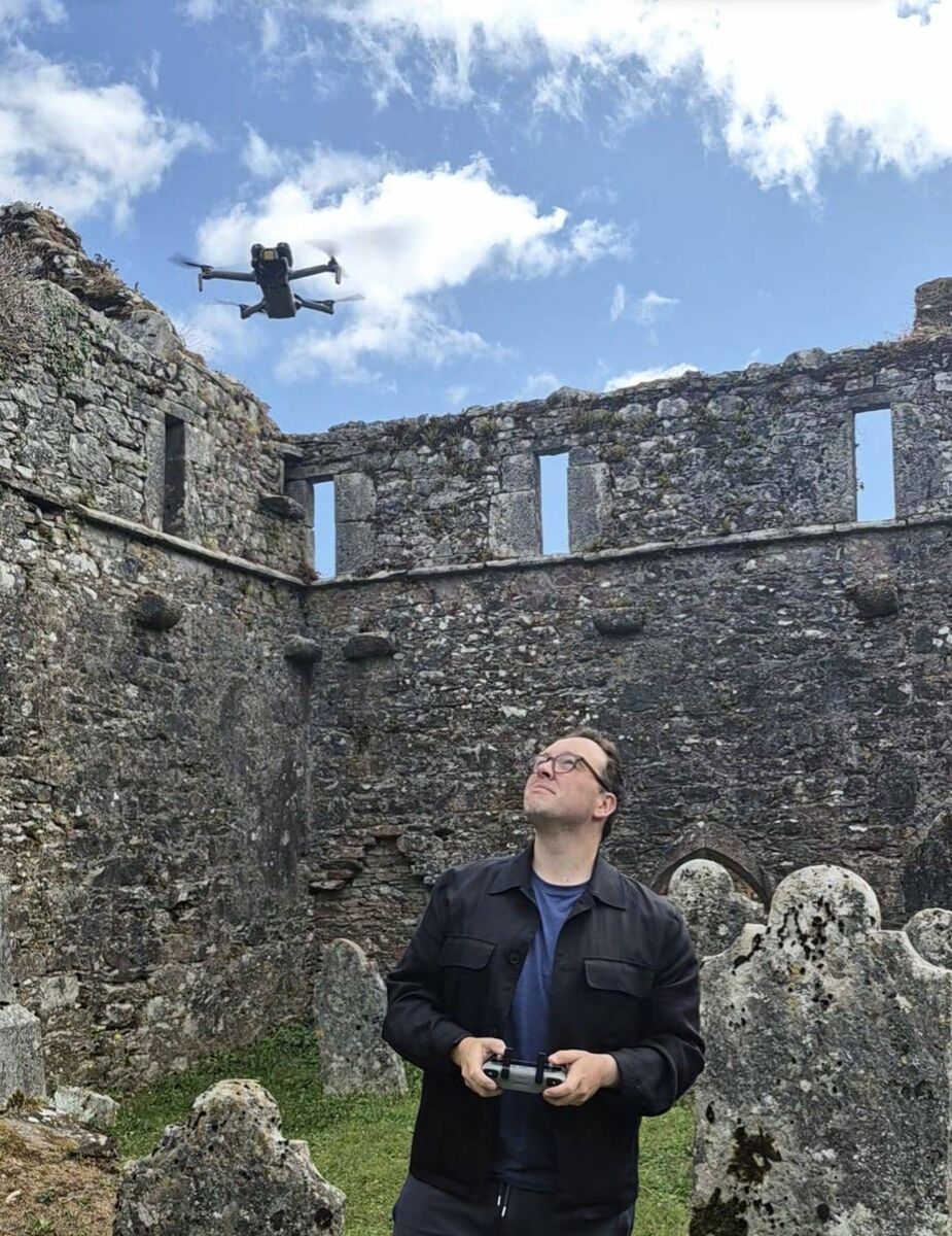 Hugh Wright at the entrance to Kilcrea Abbey near Ovens with a drone. He says he is drawn to historical places that are stuck in time. 