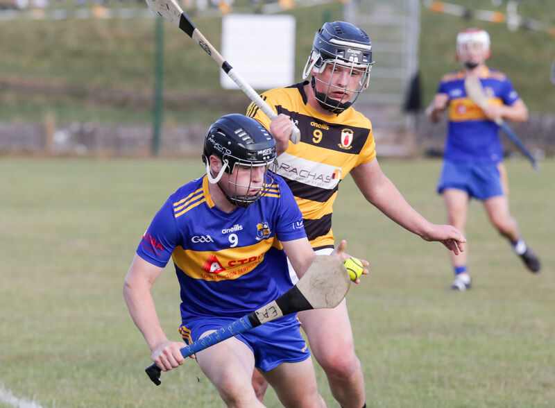 Carrigaline's Eoghan Ahern tries to break away from Na Piarsaigh's Jamie Coughlan. Picture: David Creedon