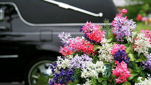 157375533 Funeral Concepts: Hearse and Flowers