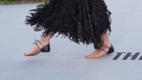 Margaret Qualley walks white carpet in barefoot Chanel sandals