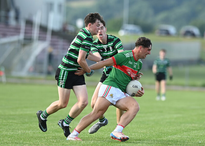 Clonakilty's Tom Whooley gets away from Douglas' Conor McLoughlin and Emmet Cronin. Picture: Martin Walsh