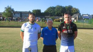 <p>Referee Cathal Egan accompanied by Anthony Harte (St Vincent's) and Ruairí Quinlan (White's Cross) at Ballinlough. </p>