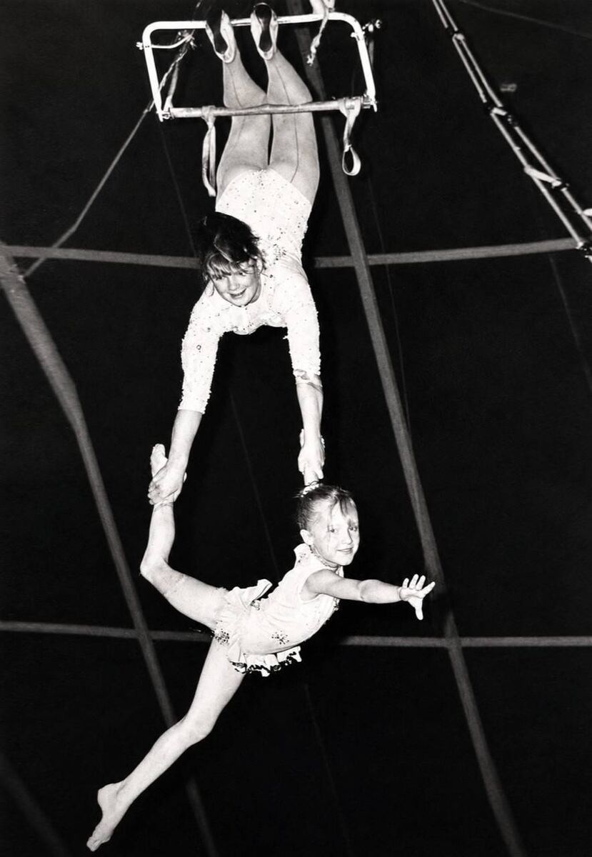 Elaine Courtney, age 7, and her sister Jacquline performing high in the roof of a circus Big Top. Elaine Courtney, age 7, and her sister Jacquline performing high in the roof of a circus Big Top.