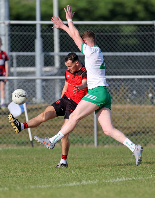  Ben Seartan, Beal Atha'n Ghaorthaidh, shoots from Christopher Mullane, Kanturk during their SAFC clash at Ballyanley. Picture: Jim Coughlan.