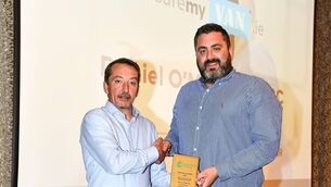 <p>UCC Demons head coach Daniel O'Mahony, right, is presented with the Men's Division One Coach of the Year award by Men's National Competitions Committee member Paul Barrett during the 2021/22 Basketball Ireland Annual Awards and Hall of Fame ceremony in Dublin</p>
