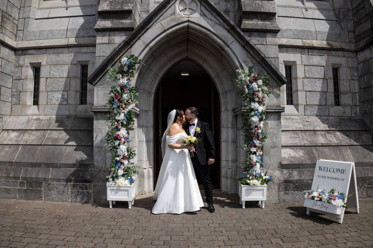 Julie made the flower arrangements for the arch outside the church and the pews, with the groomsmen helping to assemble these on the day. Julie made the flower arrangements for the arch outside the church and the pews, with the groomsmen helping to assemble these on the day.