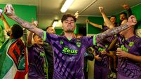 Ruairi Keating celebrates in the dressing room after his side is confirmed First Division champions 4/9/2026