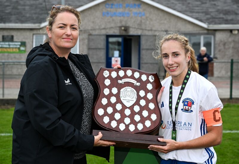 Wilton United captain Lydia Looney is presented with the Shield by FAI board member Laura Finnegan. Picture: Brendan Moran/Sportsfile