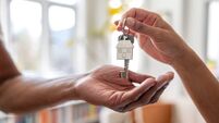 Real estate agent giving the keys of a new house to a man