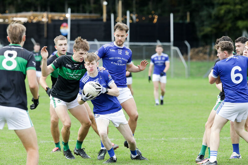 Naomh Abán's Shane Ó Loingsigh tries to break away from Nemo Rangers' Dave Coughlan. Picture: David Creedon Naomh Abán's Shane Ó Loingsigh tries to break away from Nemo Rangers' Dave Coughlan. Picture: David Creedon