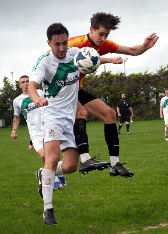 Waterloo's Sam Kelleher and Mogeely's Matt Sweetnam challenge for possession in the action at the Whitechurch Community Grounds. Picture:Barry Peelo. Waterloo's Sam Kelleher and Mogeely's Matt Sweetnam challenge for possession in the action at the Whitechurch Community Grounds. Picture:Barry Peelo.