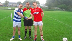 <p>Referee Cathal Ó Murchú, accompanied by Danny Moore (Ballyphehane) and Shane O'Donovan (Mayfield) </p> <p>Referee Cathal Ó Murchú, accompanied by Danny Moore (Ballyphehane) and Shane O'Donovan (Mayfield) </p>