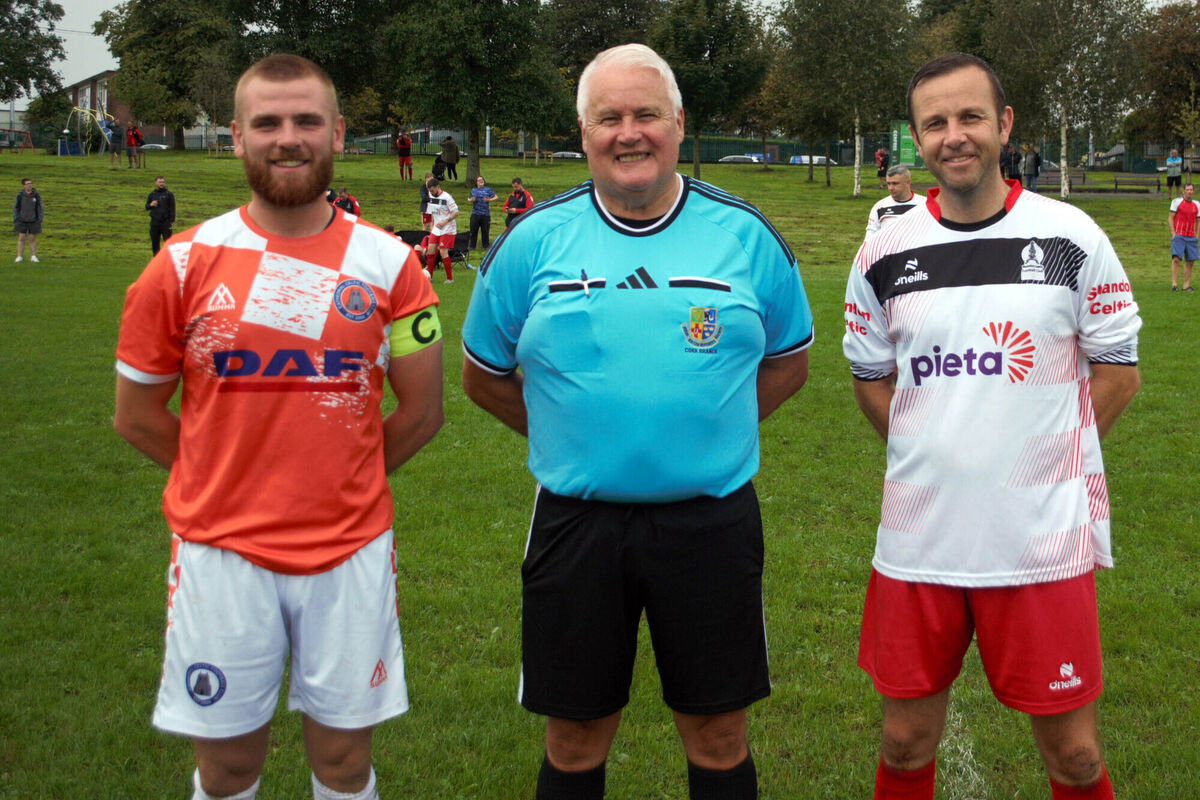 Shandon Celtic's captain Glen Cambridge (right), with Cathedral Celtic's Eoin O'Connell, accompanied by referee Jim Hennessy.