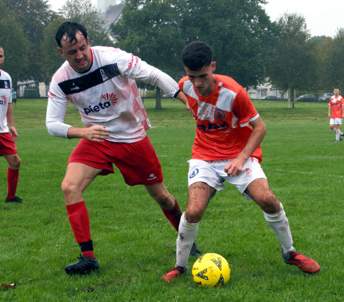 Cathedral's Danny O'Shea shields possession from Shandon's Jonathon Cronin.