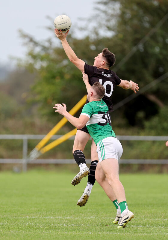 Adrian Carroll, Kiskeam, gets possession ahead of Noe Kollar, Macroom. Picture: Jim Coughlan. Adrian Carroll, Kiskeam, gets possession ahead of Noe Kollar, Macroom. Picture: Jim Coughlan.