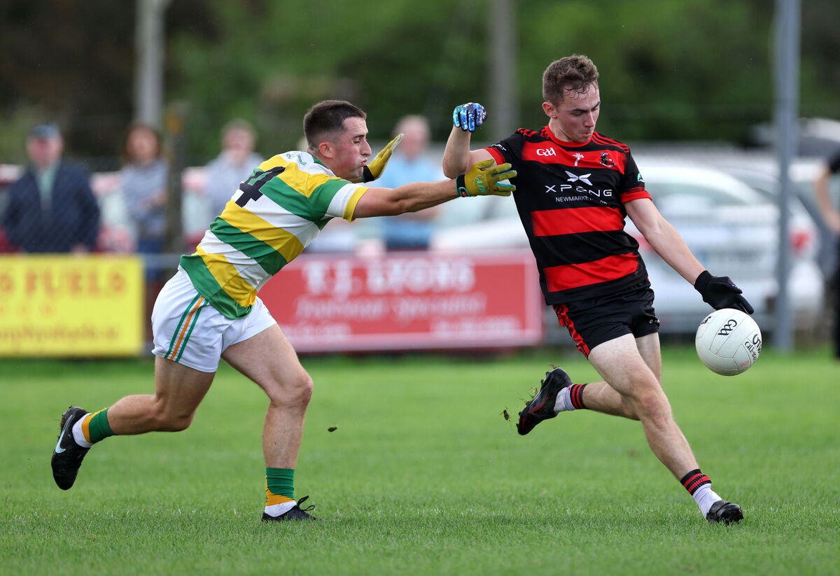  Sam Lenihan, Carbery Rangers, closes in as Brion O'Keeffe shoots for Newmarket. Picture: Jim Coughlan.