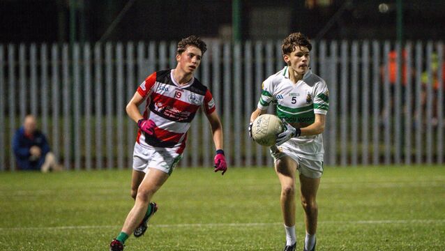 <p>Macroom’s Con Moss looks for an opening chased by Ballincollig’s Ollie Harrington in a recent U16 game. Picture: Chani Anderson</p>