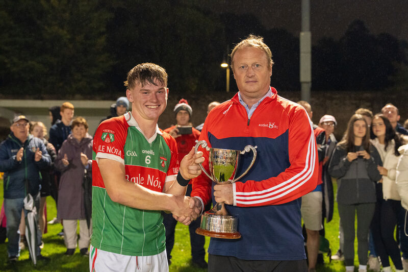Peter Watson from Rebel Óg presents the cup to Ballinora captain Fionn Murphy. Picture by Noel Sweeney
