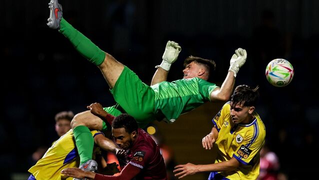<p>Longford Town goalkeeper Kian Moore collides with Jordan Adeyemi of Cobh Ramblers in a recent game. Picture: Michael P Ryan/Sportsfile</p>
