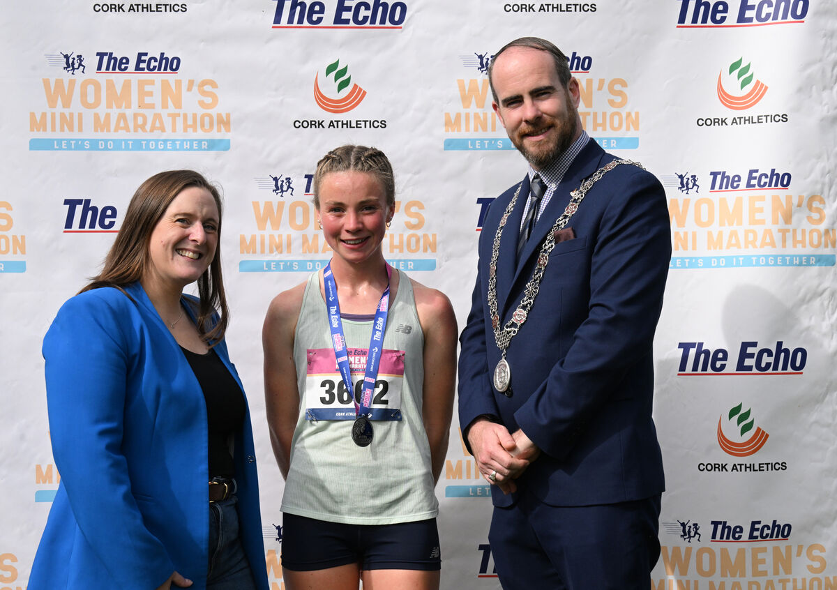 Níamh O'Mahony of An Ríocht takes the win in The Echo Women's Mini-Marathon 2026, pictured with Mary Corcoran of The Echo and Cllr Gary O'Brien, deputising for the Lord Mayor. Picture: Larry Cummins Níamh O'Mahony of An Ríocht takes the win in The Echo Women's Mini-Marathon 2026, pictured with Mary Corcoran of The Echo and Cllr Gary O'Brien, deputising for the Lord Mayor. Picture: Larry Cummins