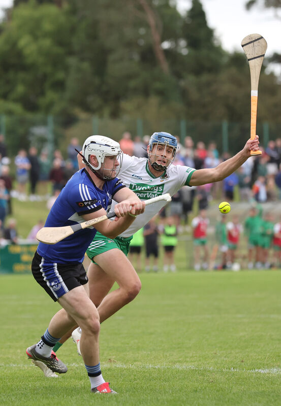  Eoghan Murphy, Sarsfields, clears from Colin Walsh, Kanturk. Picture: Jim Coughlan.