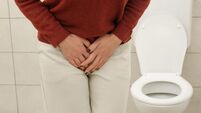 Woman Experiencing Lower Abdominal and Bladder Pain in Bathroom ? Urinary Tract Infection, Cystitis, Cramps and Digestive Discom