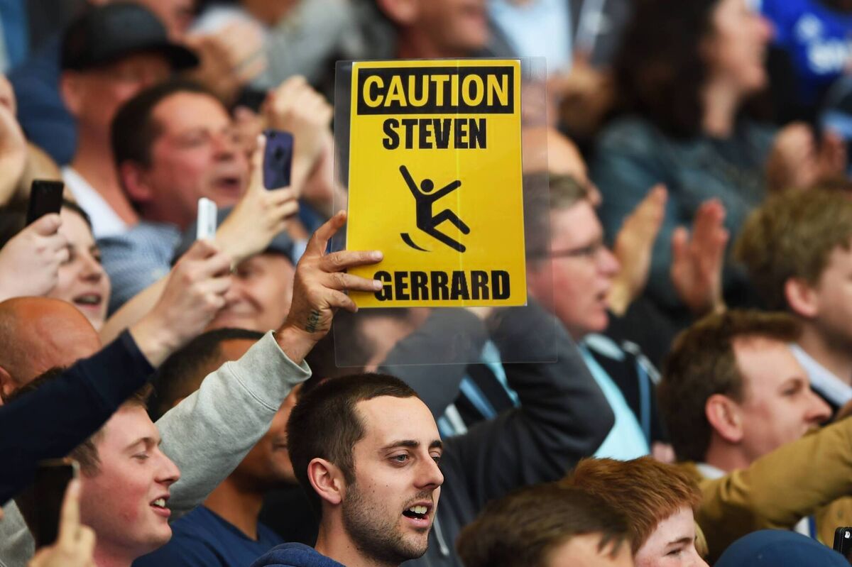 Chelsea fans hold up a sign in reference to Steven Gerrard of Liverpool slipping against their team in 2014, which was believed to have cost them the league title. But maybe City's infractions really cost him a medal? Picture: Shaun Botterill/Getty Images