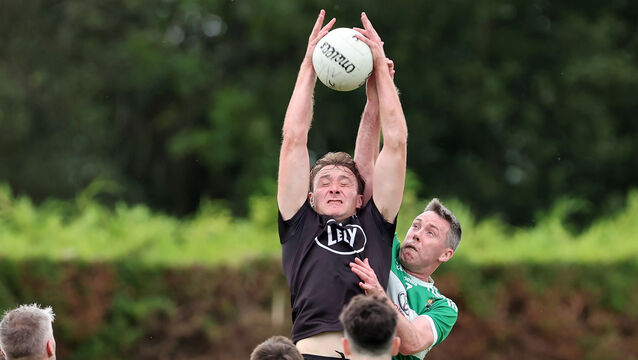 <p>Kiskeam's Seán Meehan contests a dropping ball against Macroom. Picture: Jim Coughlan</p>