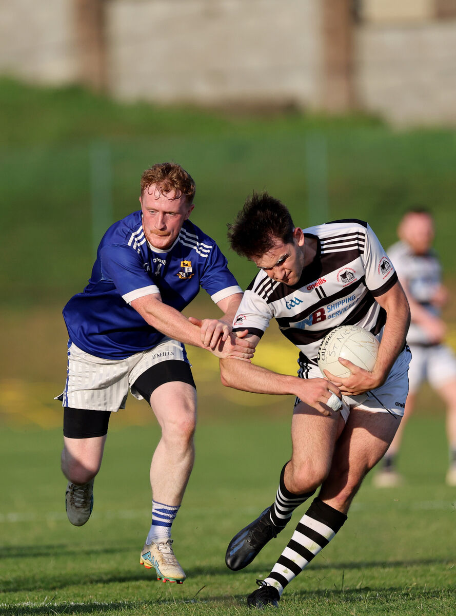  Jake Brosnan, St Nicks, tries to get away from John Lynch, Aghinagh. Picture: Jim Coughlan.