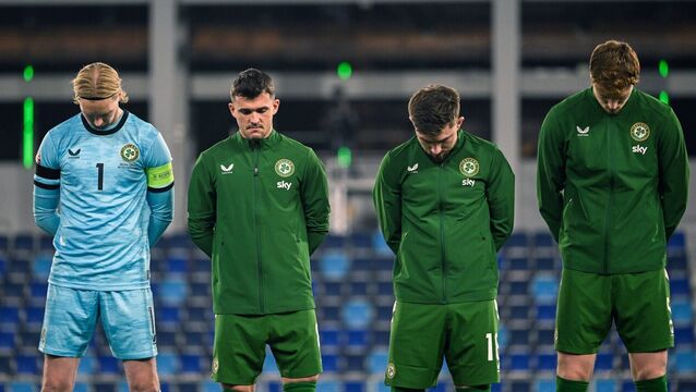 <p>Republic of Ireland players, from left, captain Caoimhín Kelleher, Ryan Manning, Jake O'Brien and Conor Coventry, wearing black armbands in recognition for all the lives lost in the conflict in Gaza, bow their heads during the Israeli national anthem before the UEFA Nations League B match between the Republic of Ireland and Israel at TSC Arena in Bačka Topola, Serbia. Photo by Stephen McCarthy/Sportsfile</p>