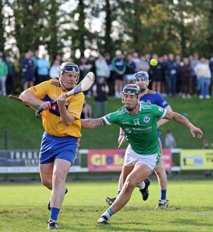  Rob Foster, Carrigaline goalkeeper, clears from James Dwyer, Ballincollig. Picture: Jim Coughlan.