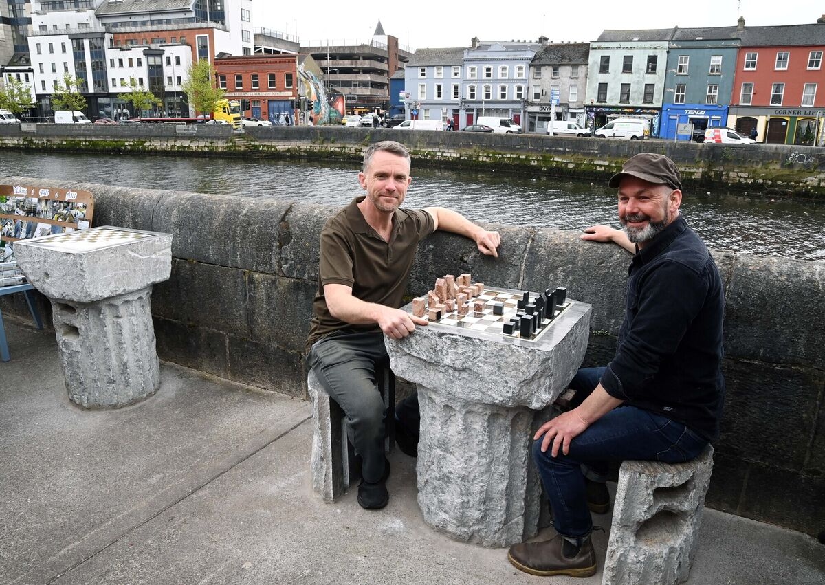 Tommy Lysaght, (right) stone carver, at Pope's Quay with Liam Mullaney of Myo Café, at the carved chess tables, in 2023. Picture: Denis Minihane.