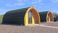Wooden Glamping pod in a glamping village with yurts and gravel paths Ireland