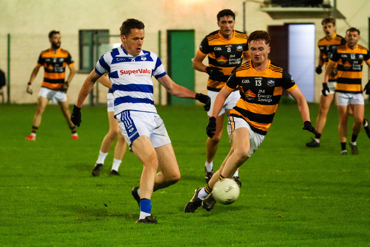 Inniscarra’s David Coughlan passes from Jason Riordan of Canovee. Picture: Noel Sweeney