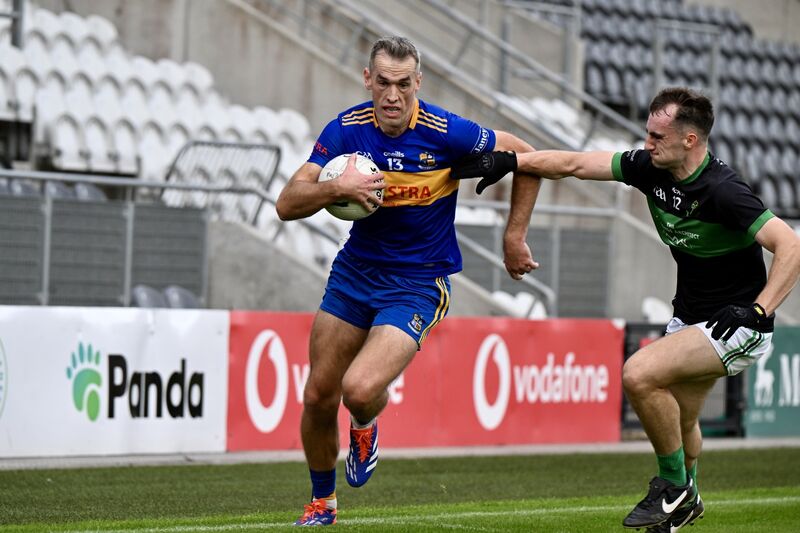 Carrigaline's Niall Coakley tries to hold off a challenge from Conor Shalloe, Nemo Rangers. Picture: Larry Cummins