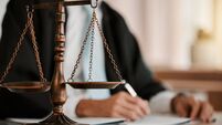 Closeup, scales and law on table, office and attorney man in blurred background with reading for crime analysis. Advocate, lawye