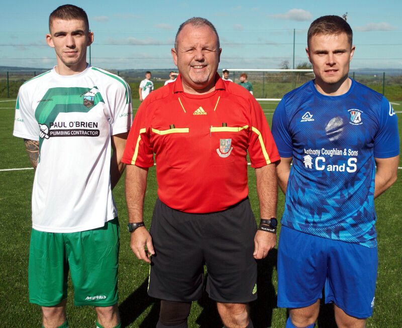 AUL Photos Waterloo FC's captain Jack Homan (left), with Grattan United A's David Curtin, accompanied by referee Paul O'Sullivan. AUL Photos Waterloo FC's captain Jack Homan (left), with Grattan United A's David Curtin, accompanied by referee Paul O'Sullivan.