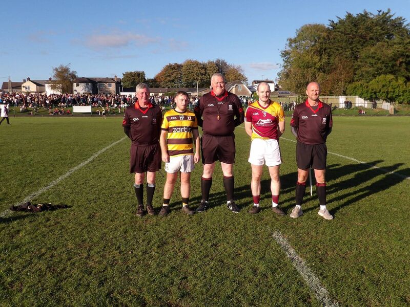Referee Pat Lyons accompanied by captains Michael Sheehan (Na Piarsaigh) and Killian Ryan (Whitechurch). Also included are linesmen Mark Maher and Danny Duggan. 