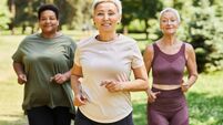 Asian middle-aged woman in active wear jogging with female friends in the park during daytime