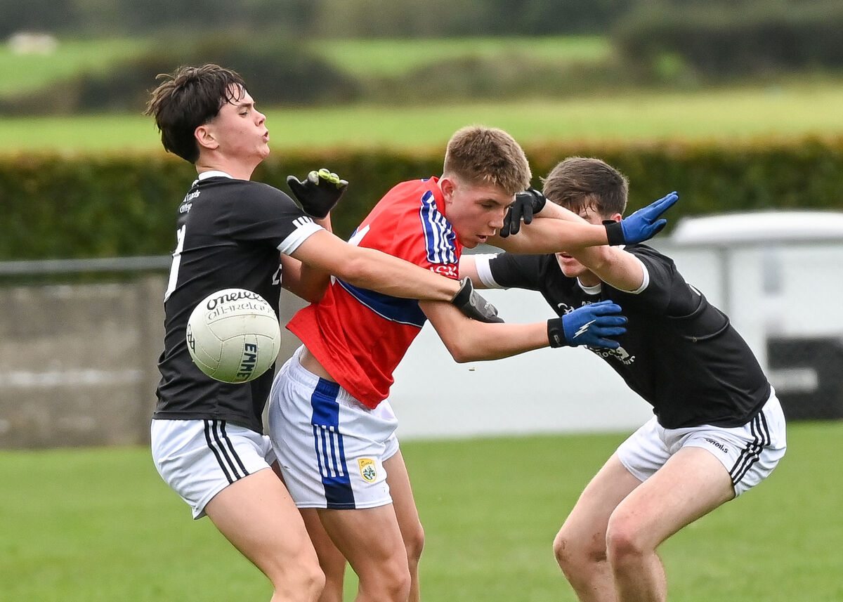  Adam Kelly and Darragh O'Flaherty of St Francis College Rochestown battling for possession with Lachlan Scannell of Intermediate School Killorglin during their TUS Corn Ui Mhuiri clash at Glanworth.
