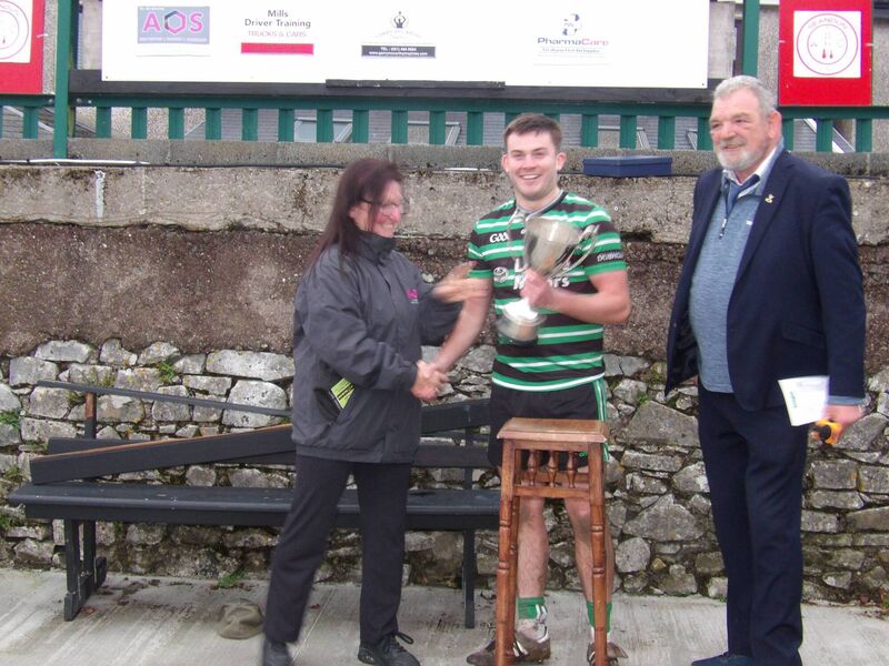 Jess O'Sullivan (AOS Security MD) presents the trophy to Douglas captain Joe Cremin at Ballinlough, with Seandún chairman Mick Buckley. Jess O'Sullivan (AOS Security MD) presents the trophy to Douglas captain Joe Cremin at Ballinlough, with Seandún chairman Mick Buckley.