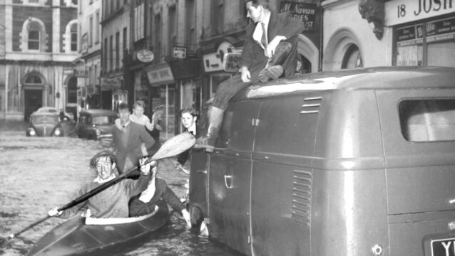 <p>Donal McCarthy and Joey Kerrigan rescue a stranded driver from the floods in Winthrop Street, Cork. </p>