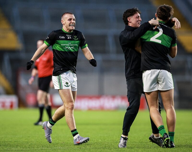 Nemo Rangers players Colin Molloy, right, and Conor Horgan celebrate with a supporter. Picture: Thomas Flinkow/Sportsfile