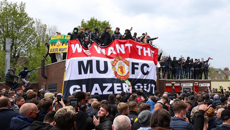 Fans hold up banners as they protest against the Glazer family, owners of Manchester United. Fans hold up banners as they protest against the Glazer family, owners of Manchester United.