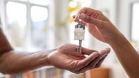 Real estate agent giving the keys of a new house to a man