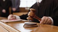 Judge holding gavel in courtroom