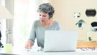Senior woman checking bills