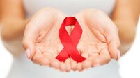 hands holding red AIDS awareness ribbon