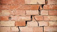 Deep crack in old brick wall - concept image